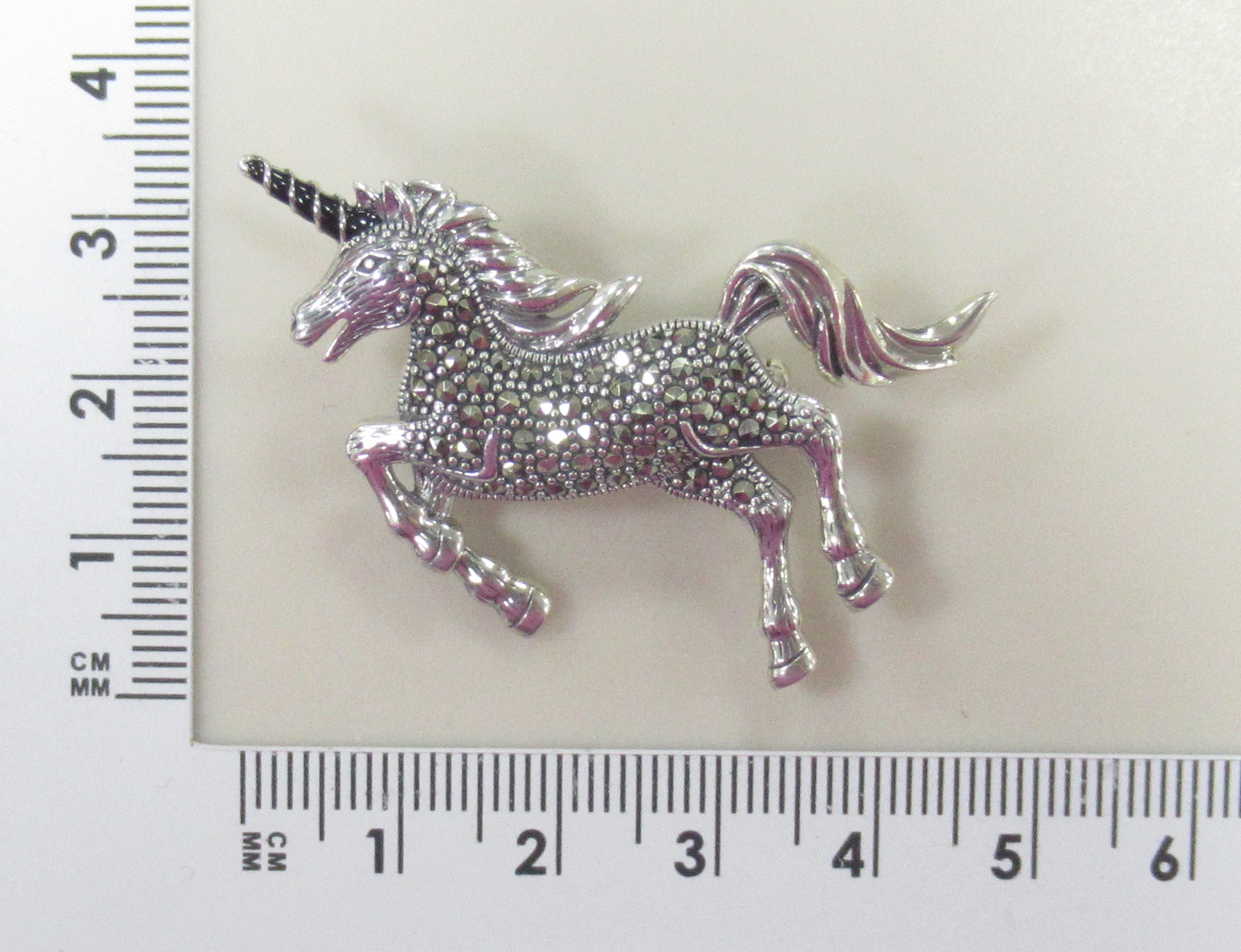 Серебряная брошь с марказитами "Единорог"
